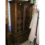 A modern Oak finished glazed Display Cabinet on two door base, three shelves,