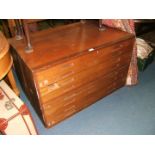 A circa 1970 Teak Plan Chest, rectangular in shape with eight drawers and recessed wooden handles.