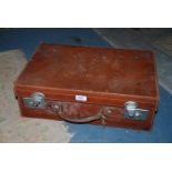 A brown leather Suitcase,
