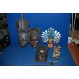 Two hand-crafted Ebony Tribal wooden Masks and three other masks.