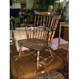 A Good Quality Ercol Dark Elm Windsor Rocking Fireside Armchair.