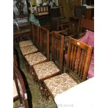 A set of six 1940's Oak Dining Chairs including one carver with fret cut slat backs,