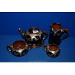 **A five piece stoneware Teaset in cobalt blue with gilt Stork decoration