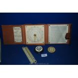 A cased Artillery Wind Correction Indicator,