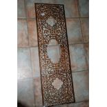 A decorative antique fret cut wooden panel,