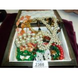 A box of costume jewellery including necklaces, bracelets, etc.