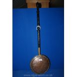 A Copper warming pan with wooden handle