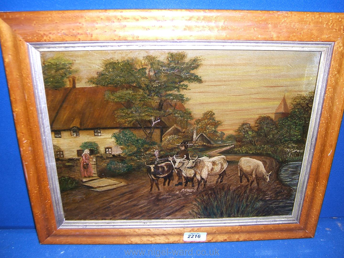 An Oil on canvas of Cows in a maple frame