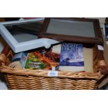 A basket of books incl Novels together with a frame and a mirror