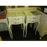 A pair of white painted French style bedside cabinets.