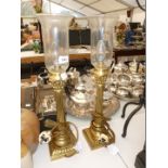 A pair of Brass column Lamps with glass shades.