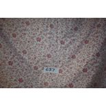 A double rose coloured and floral patterned Bed Cover.