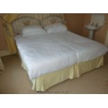 A pair of Twin Beds with upholstered cream ground, floral print headboards.