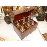 A Mahogany Decanter Box containing six gilt decorated bottles.