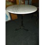 A marble topped Table with cast iron base, 30" diameter.