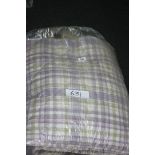 A quilted king size Bed Cover in lavender and green check pattern.