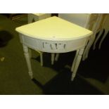 A modern white painted Corner Table with leaf design single drawer.