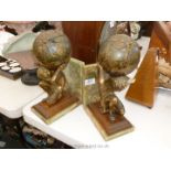 A pair of modern Bookends of onyx and wood in the form of Atlas holding globe