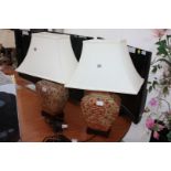 A pair of oriental style red and cream Table Lamps with rectangular cream shades,