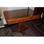 A Victorian Walnut and other woods Tea Table with ornate pedestal.