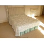 A 5' double Bed with beige padded headboard.