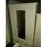An Edwardian white painted Wardrobe with mirrored door and drawer to base, 42" wide x 80" high.