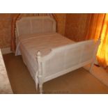 A white painted, French style 5' Double Bed with rattan/cane head and foot boards.