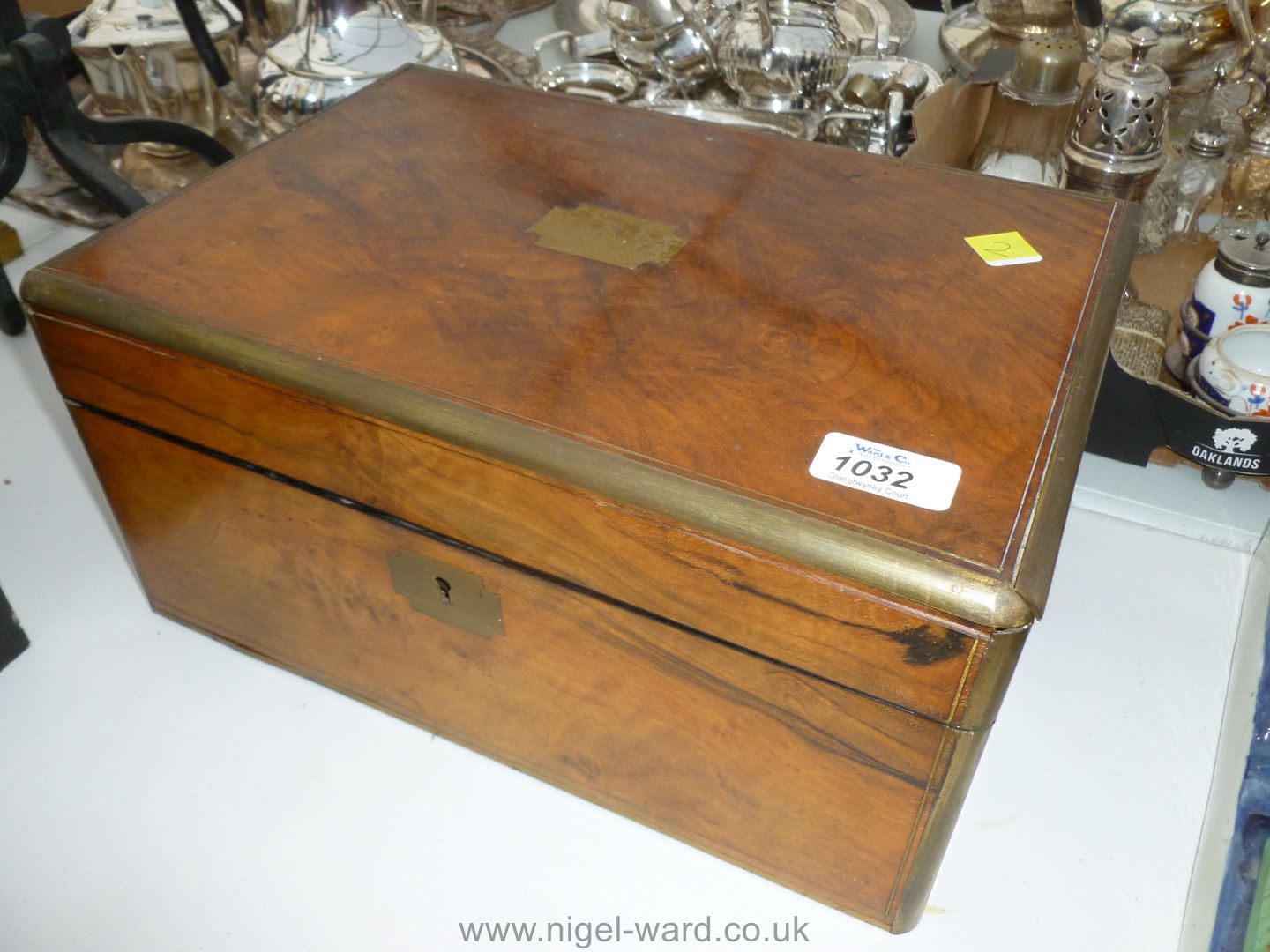 A Walnut Writing Slope Box with inset brass escutcheon.