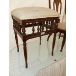 A Victorian upholstered Stool with bobbin turned detail.