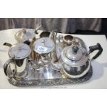 A rectangular plated Tray with several Teapots,