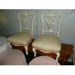 A pair of lyre backed, white painted Edwardian Nursing Chairs with cream and pink upholstered seat.