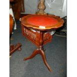 A red leather topped Wine Table.