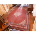 A large red ground Eastern style Rug, with diamond motif to centre, 55" x 120".