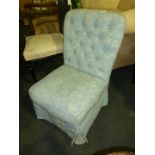 A blue upholstered, button back Nursing Chair.