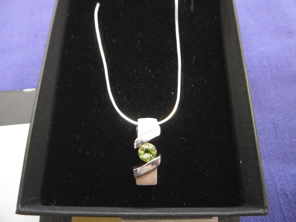 SILVER CHARM AND PERIDOT PENDANT