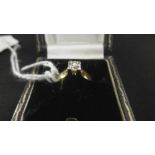 A YELLOW METAL MARKED 18K AND DIAMOND SOLITAIRE RING