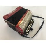 ACCORDION - a Hohner Erica Accordion with red case and white keys.