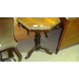 Victorian carved wine table on tripod legs