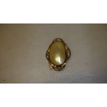 Antique shell brooch mounted in unmarked gold coloured metal