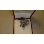 Silver dragon pendant and vintage unmarked gold metal brooch set with garnets