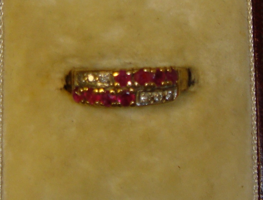 Modern 9 ct gold ring set with a multitude of small rubies and diamonds