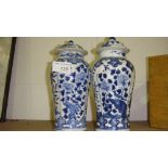 Harlequin pair of Chinese blue and white Kang zi vases with lids (with damages)