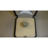 18 ct gold ring set with a star shape cluster of diamonds in presentation case