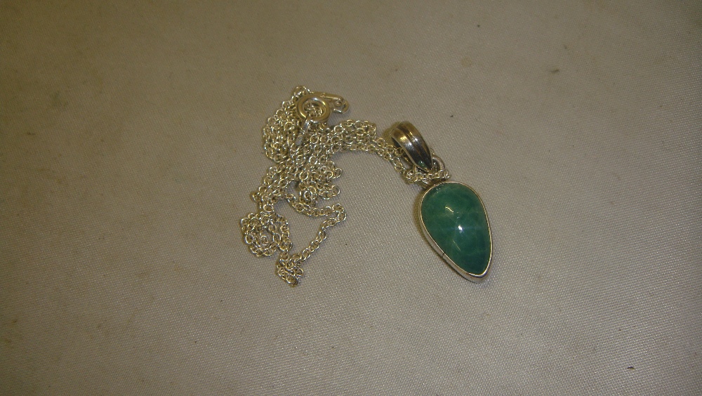 Modern green stone pendant set in silver on chain