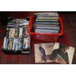 Two boxes of assorted DVDs and records to include easy listening.