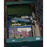 A box of books and tins including Giles annuals etc.