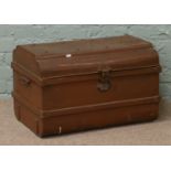 A painted steel dome top travel trunk with twin handles.