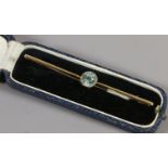 A cased 15ct gold bar brooch set with a circular blue zircon stone c1925.