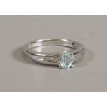 A 9ct white gold ring set with an aquamarine stone and having diamond set shoulders, size T.