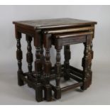 A nest of three mahogany coffee tables raised on turned supports.